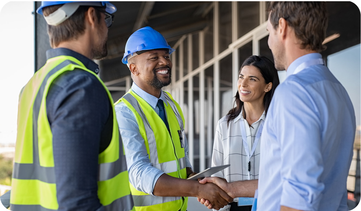 Construction team shaking hands at site.