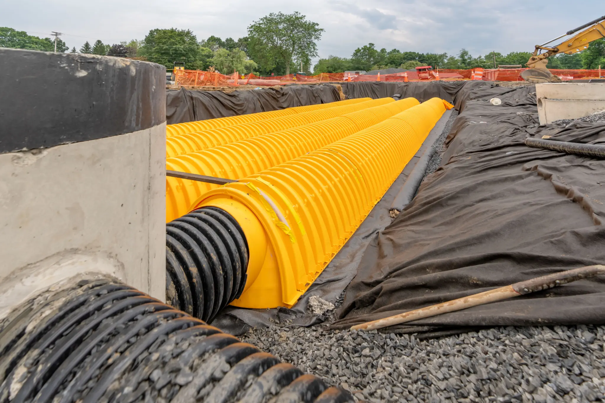 Construction site with yellow drainage pipes.